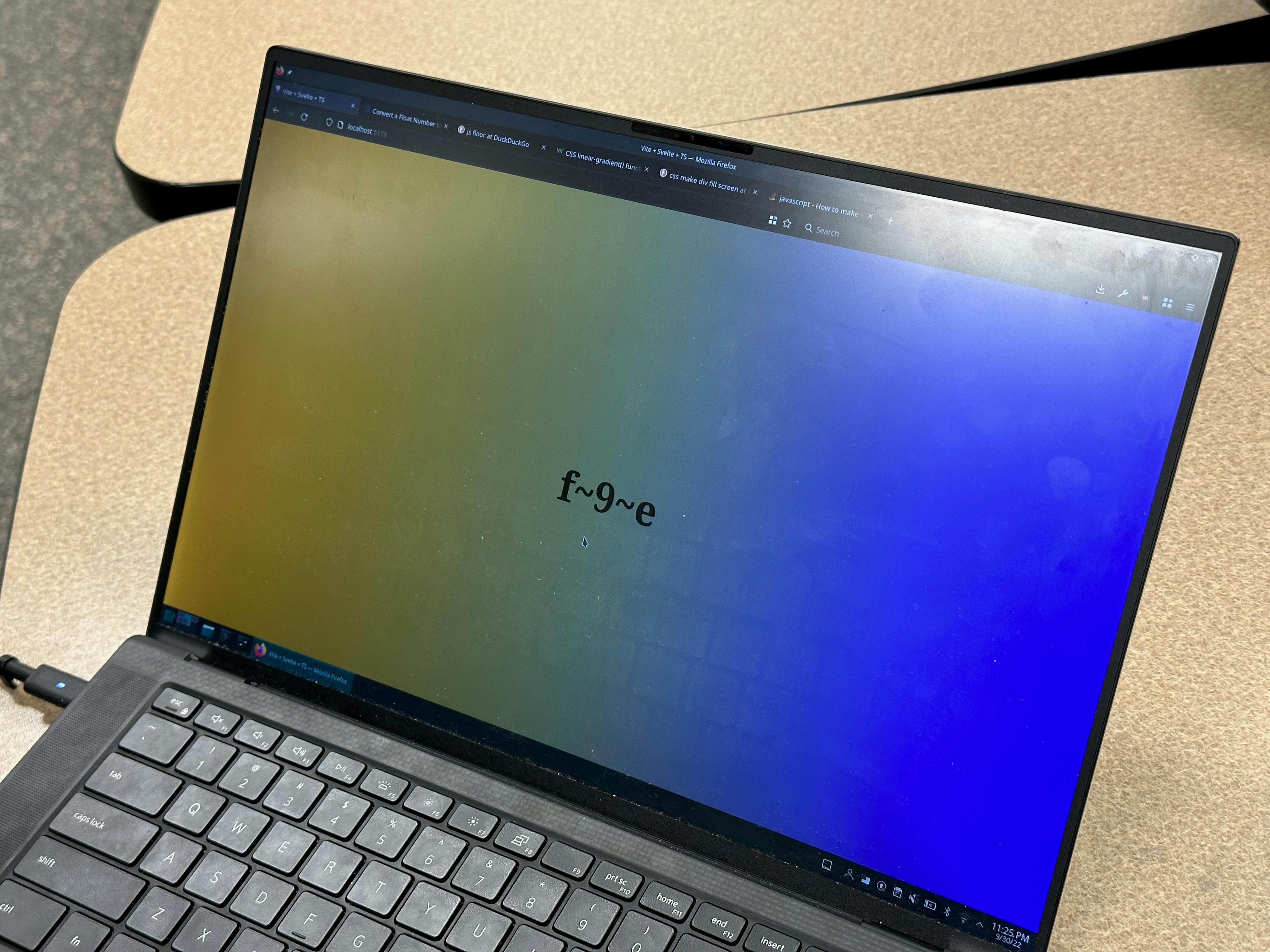 a close-up of a laptop with a website open showing a lightning time clock. a lightning time string is in the
middle of the page, and the background of the page is a gradient of the three colors representing
that time.