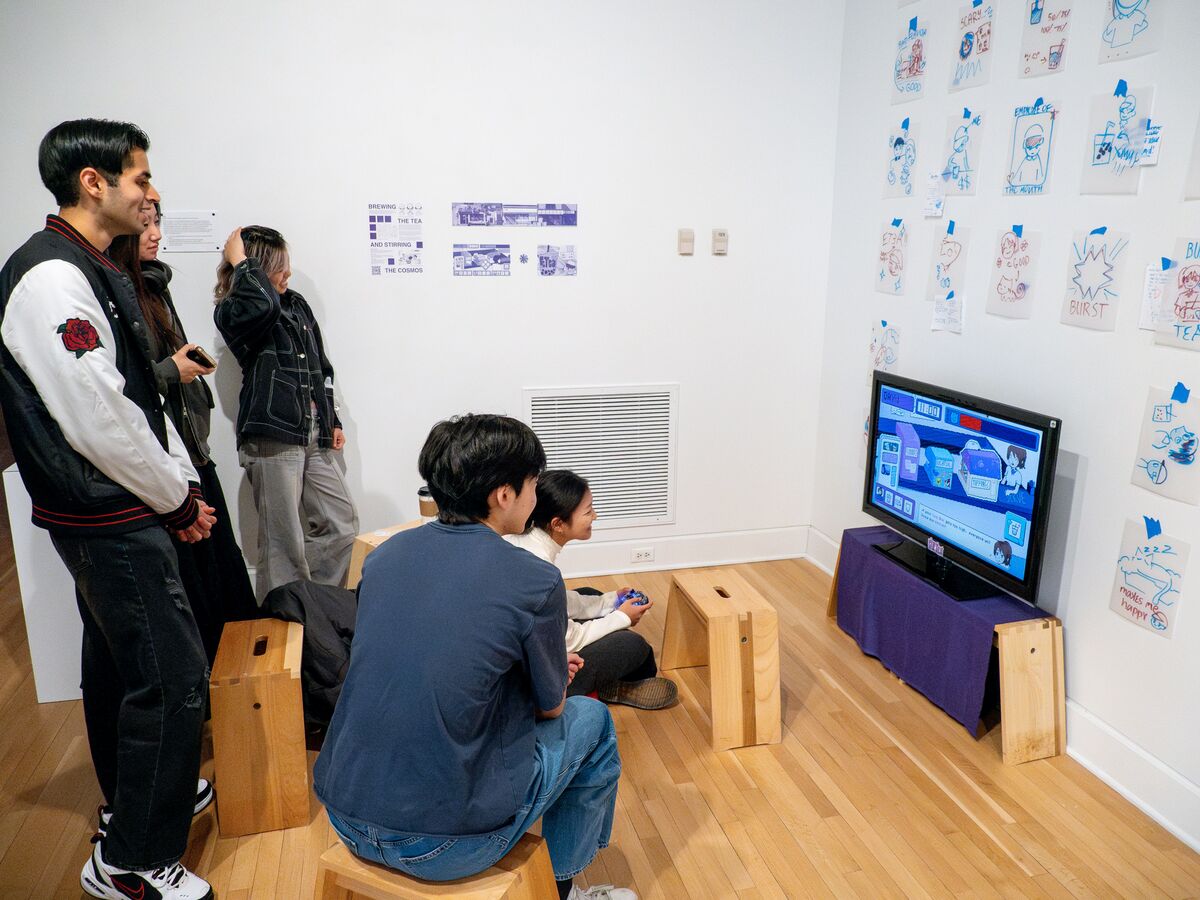people seated around a screen showing a video game